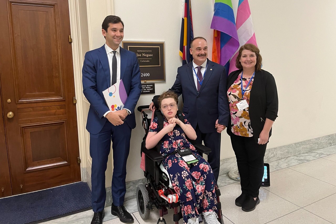 The Cummins family of Colorado Springs get their photo taken with Rep. Joe Neguse's staffer outside his office in Washington D.C.